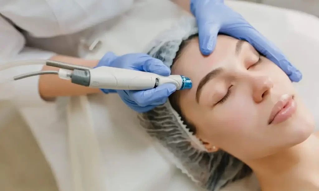Woman receiving hydrafacial or advanced facial treatment at a skin clinic