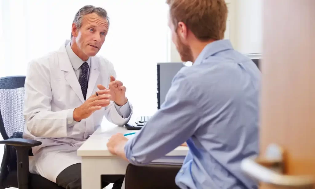 Doctor consulting with a male patient during a medical or dermatology appointment