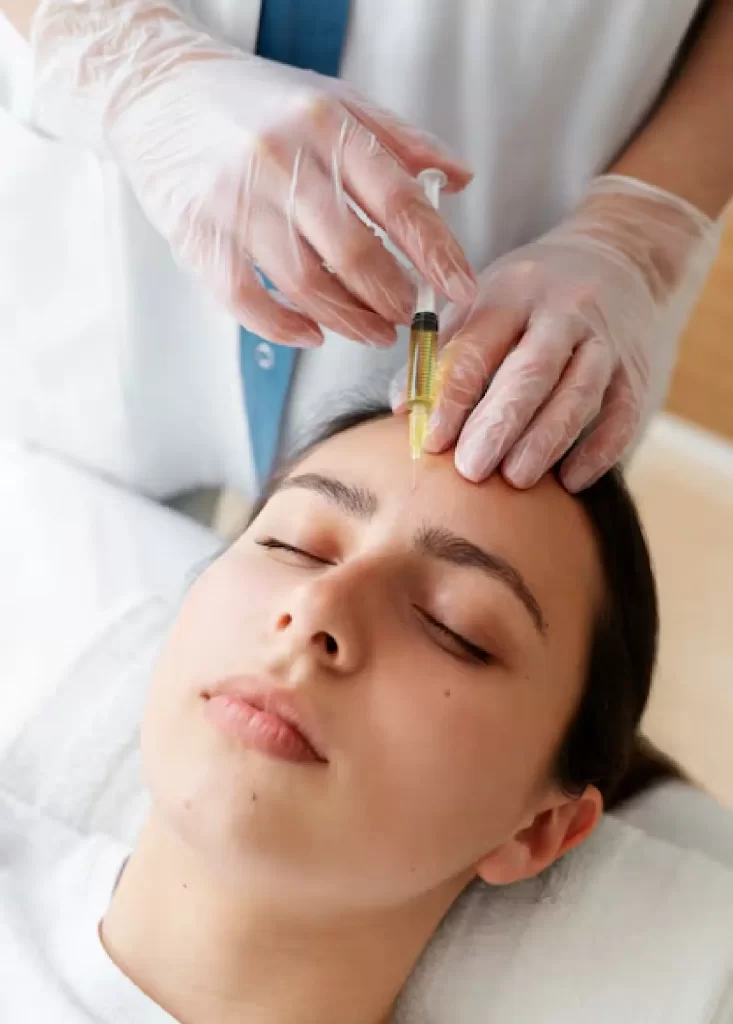 Woman receiving anti-ageing injectable treatment on the forehead at a skin clinic