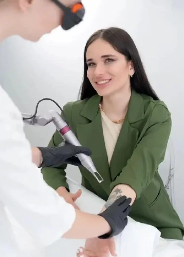 Laser tattoo removal consultation and treatment on a woman's forearm at Emara Skin Clinic